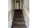 Carpeted staircase with white railings leading to the upper level of the home at 683 Wood Path Ct, Stone Mountain, GA 30083