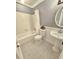 Well-lit bathroom featuring a bathtub, toilet, pedestal sink, and a neutral color scheme at 738 Brentwood Pl, Marietta, GA 30067