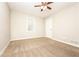 Well-lit bedroom with ceiling fan and carpet flooring at 1005 Quail Dr, Stockbridge, GA 30281