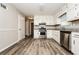 Bright kitchen featuring white cabinets, stainless steel appliances, and hardwood floors offering ample space and functionality at 1005 Quail Dr, Stockbridge, GA 30281