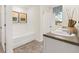 Bathroom featuring double vanity, garden tub, natural light, and neutral colors at 353 Sound Cir, Stockbridge, GA 30281