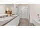 Bathroom featuring double vanity, framed mirror, a garden tub, and glass door shower at 353 Sound Cir, Stockbridge, GA 30281