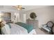 Bedroom with a tray ceiling, neutral color, natural light, and a dresser with decorative mirror at 353 Sound Cir, Stockbridge, GA 30281