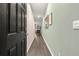 Welcoming hallway with hardwood floors and stylish wall decor, creating an inviting entrance to the home at 353 Sound Cir, Stockbridge, GA 30281