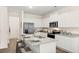 Modern kitchen with white cabinets, stainless steel appliances, and granite countertops at 353 Sound Cir, Stockbridge, GA 30281