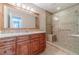 Bathroom with granite countertop, wood cabinets and a large walk in shower at 2612 Cliffview Dr, Lilburn, GA 30047