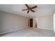 Spacious carpeted bedroom with ceiling fan and neutral walls at 2612 Cliffview Dr, Lilburn, GA 30047