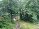 Overlooking a pond with a stone path and lush greenery at 2612 Cliffview Dr, Lilburn, GA 30047