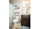 Cozy bathroom with a toilet, vanity, mirror, and a cabinet for storage at 264 Magnaview Dr, Mcdonough, GA 30253