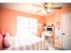 Bedroom with a bed, desk, and ceiling fan with a large window for light at 264 Magnaview Dr, Mcdonough, GA 30253