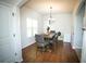 Dining room features a wood table, chandelier, and wood-look floors at 264 Magnaview Dr, Mcdonough, GA 30253