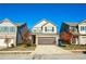 Charming two-story home with tan siding, brick accents, a two-car garage, and a well-maintained lawn at 264 Magnaview Dr, Mcdonough, GA 30253
