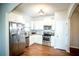 Bright kitchen features stainless steel appliances, white cabinets, and wood-look floors at 264 Magnaview Dr, Mcdonough, GA 30253