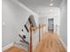 Bright hallway with wooden railing staircase and natural light at 2779 Horseshoe Knoll Ln, Roswell, GA 30075