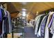 Finished attic with hanging clothes storage and shelving at 5154 Central Dr, Stone Mountain, GA 30083