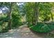 Long driveway leading to home, surrounded by lush trees and landscaping at 5154 Central Dr, Stone Mountain, GA 30083