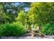 Serene garden with a stone fountain, lush greenery, and potted plants at 5154 Central Dr, Stone Mountain, GA 30083