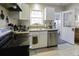Kitchen features stainless steel appliances and white cabinets at 5154 Central Dr, Stone Mountain, GA 30083