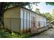 White outbuilding needing some repairs, next to chain-link fence at 5154 Central Dr, Stone Mountain, GA 30083