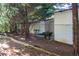 White outbuilding with chain link fence and a grilling area at 5154 Central Dr, Stone Mountain, GA 30083