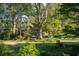 Large backyard with mature trees and lawn at 5154 Central Dr, Stone Mountain, GA 30083