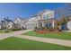 Two story home with gray siding, landscaping, and a two-car garage, view of neighborhood at 117 Neese Farm Dr, Woodstock, GA 30188