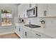 Bright kitchen with white cabinets, gas cooktop, and quartz countertops at 117 Neese Farm Dr, Woodstock, GA 30188