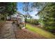 Sloped backyard with stone path leading to home and deck at 131 Gold Springs Ct, Canton, GA 30114
