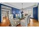 Formal dining room with hardwood floors, blue walls, and a glass table at 131 Gold Springs Ct, Canton, GA 30114