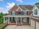 Brick home with a wrap-around porch and attached garage at 131 Gold Springs Ct, Canton, GA 30114
