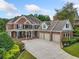 Brick house with three-car garage and landscaped yard at 131 Gold Springs Ct, Canton, GA 30114