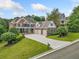 Two-story brick home with a large driveway and mature trees at 131 Gold Springs Ct, Canton, GA 30114