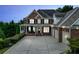 Brick house with a three-car garage at dusk at 131 Gold Springs Ct, Canton, GA 30114