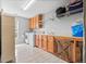 Bright laundry room featuring wood cabinets and tile floors at 131 Gold Springs Ct, Canton, GA 30114
