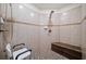 Large walk-in shower with tiled walls and bench seat at 131 Gold Springs Ct, Canton, GA 30114