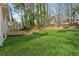 Expansive backyard featuring lush green lawn, mature trees, and a wooden deck at 3302 Mixon Way, Stone Mountain, GA 30087