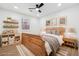 Bedroom featuring wood floors, a ceiling fan, a bed, and natural light at 3302 Mixon Way, Stone Mountain, GA 30087