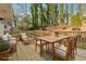 Outdoor living space showcasing deck with wood furniture and plush cushions against a wooded backdrop at 3302 Mixon Way, Stone Mountain, GA 30087
