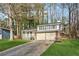Traditional two-story home with a covered porch, brick accents, and a two-car garage at 3302 Mixon Way, Stone Mountain, GA 30087