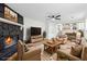 Staged living room with stairs, wood floors, fireplace, and comfortable furniture at 3302 Mixon Way, Stone Mountain, GA 30087