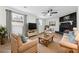 Staged living room with stone fireplace, ceiling fan, and lots of light and comfortable furniture at 3302 Mixon Way, Stone Mountain, GA 30087