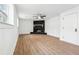 Unfurnished living room featuring wood floors, a fan, a fireplace, and doorway at 3302 Mixon Way, Stone Mountain, GA 30087