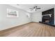 Unfurnished living room featuring wood floors, a fan, a fireplace, and lots of natural light at 3302 Mixon Way, Stone Mountain, GA 30087