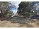 Expansive backyard featuring mature trees, lush greenery, and a charming home in the background at 3930 Peachtree Dunwoody Ne Rd, Atlanta, GA 30342