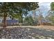 Spacious backyard with a well-maintained lawn, surrounded by a wooden fence and mature trees at 3930 Peachtree Dunwoody Ne Rd, Atlanta, GA 30342