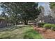 Lush backyard featuring a manicured lawn, mature trees, and carefully placed landscaping at 3930 Peachtree Dunwoody Ne Rd, Atlanta, GA 30342