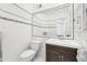 Bathroom with a dark wood vanity, a white toilet, and tiled walls at 3930 Peachtree Dunwoody Ne Rd, Atlanta, GA 30342
