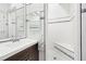 Bright bathroom with a tiled shower, decorative accents, and a stylish vanity at 3930 Peachtree Dunwoody Ne Rd, Atlanta, GA 30342