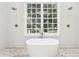 Bright bathroom with a luxurious soaking tub and dual shower heads at 3930 Peachtree Dunwoody Ne Rd, Atlanta, GA 30342