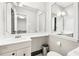 Clean bathroom with a decorative mirror, ample counter space, and a contrasting black and white tile floor at 3930 Peachtree Dunwoody Ne Rd, Atlanta, GA 30342